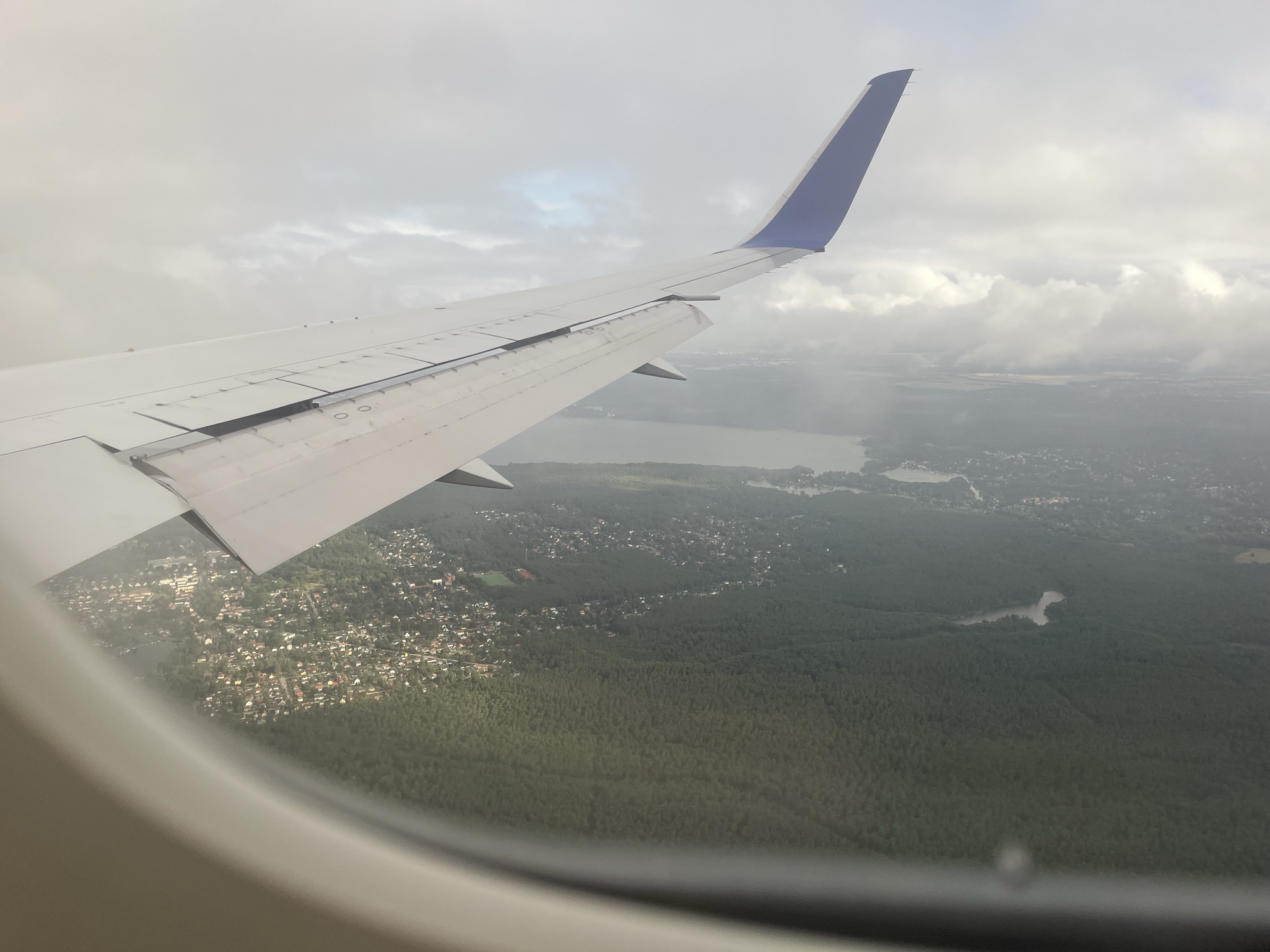The view from our window seat on approach into Berlin: the wing over lakes, forest, and red rooftops as we came in to land
