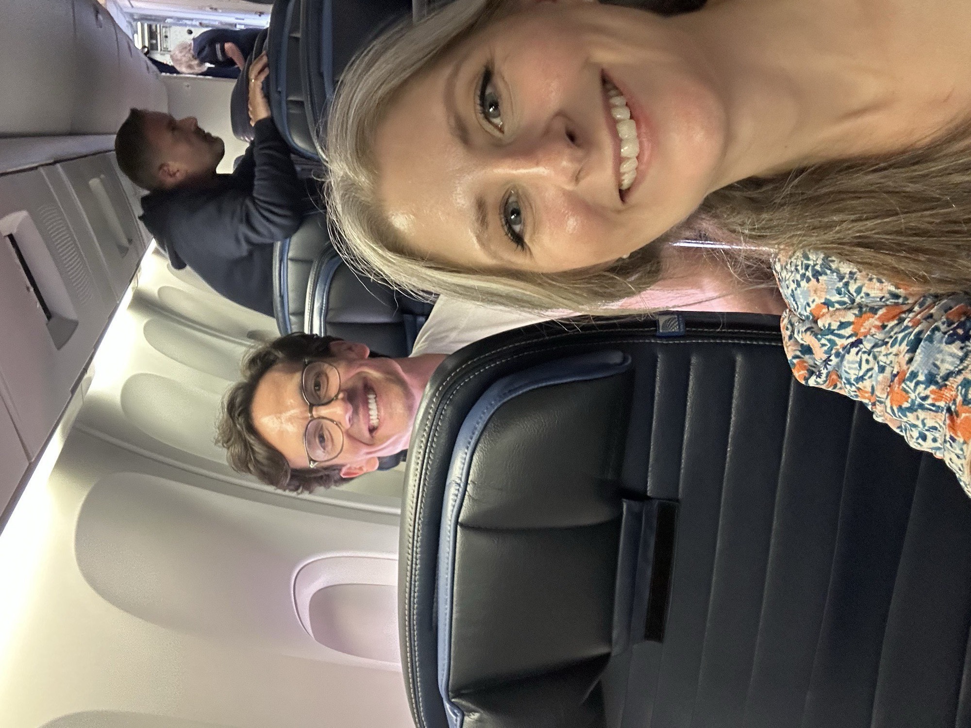 A mid-flight selfie: the two of us smiling from our seats on the plane to Berlin