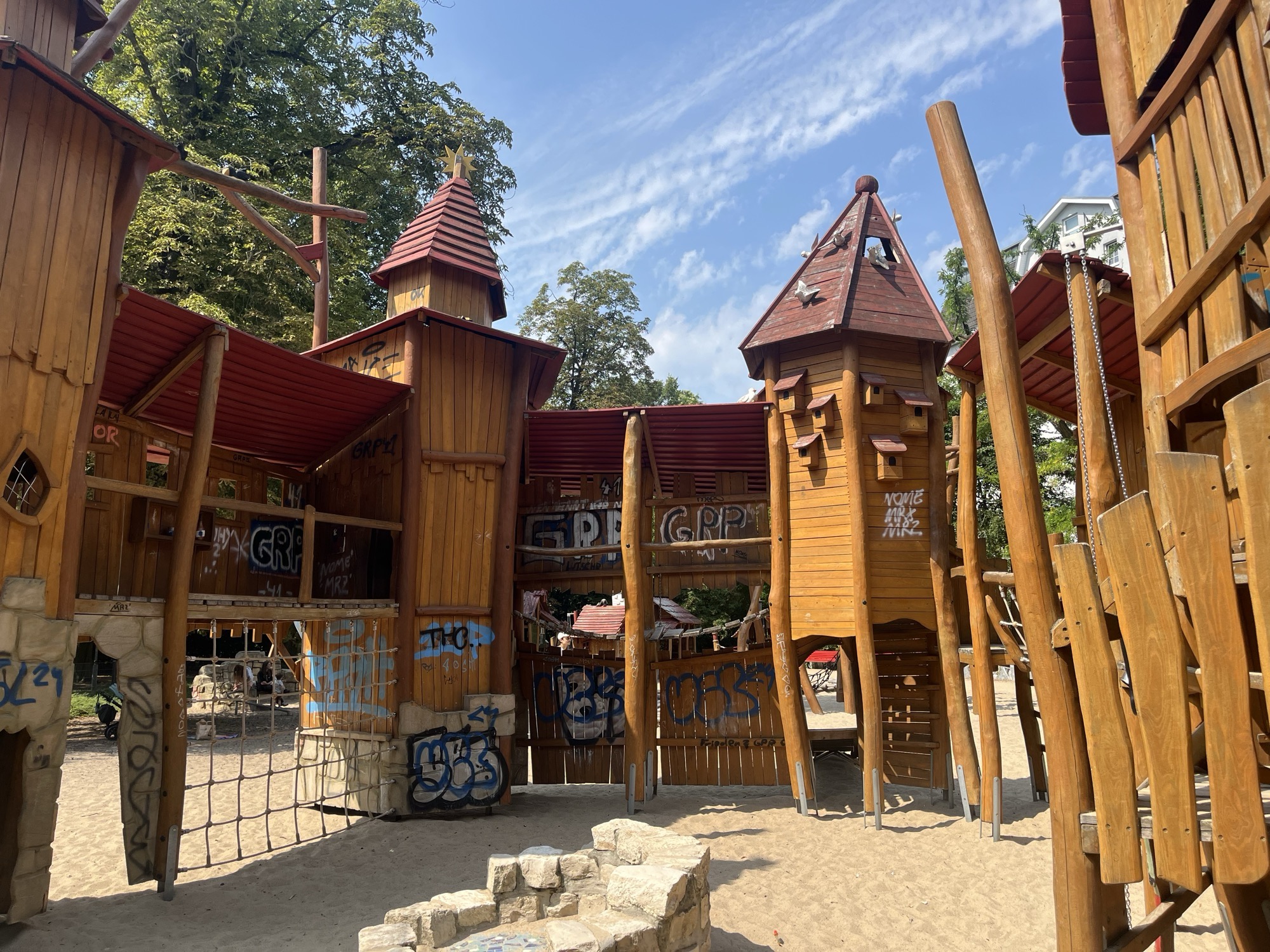 The wooden castle towers and birdhouse turrets of the fairytale playground