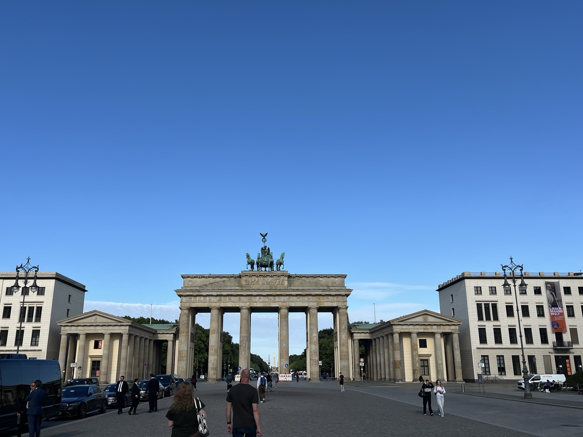 The Brandenburg Gate under a clear blue sky, the quadriga on top, seen from Pariser Platz