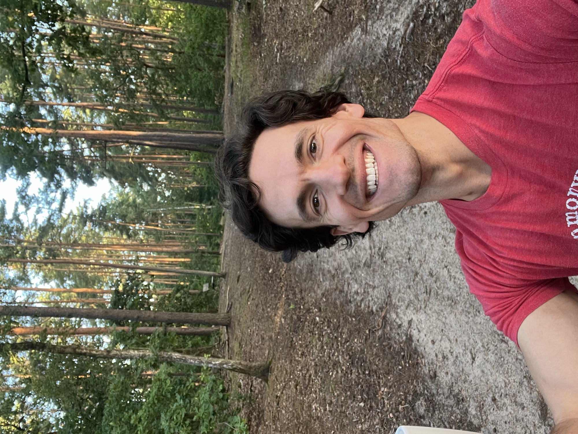 A selfie on my daily walk through Grunewald, tall pines rising along the trail behind me