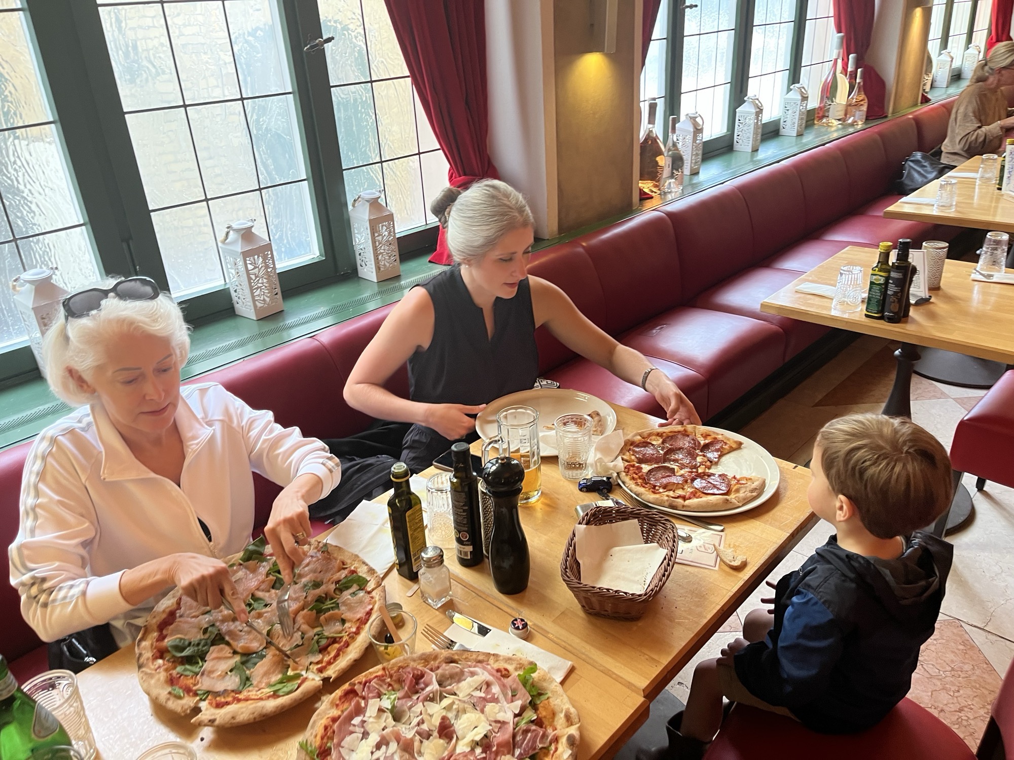 George, Liza, and Apu at the table at 12 Apostoli, three pizzas between them