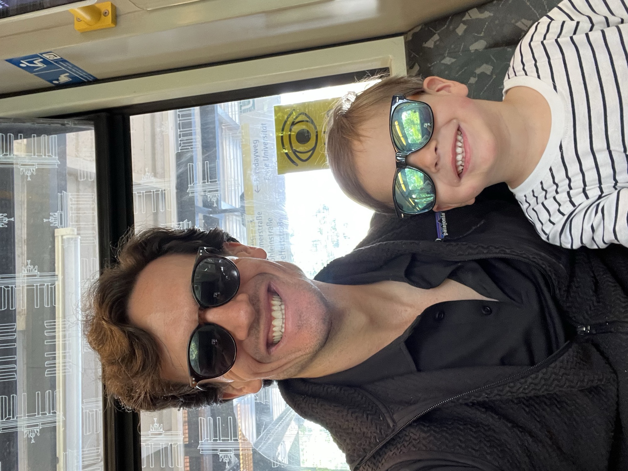 A selfie on the train: George and me in sunglasses, both grinning